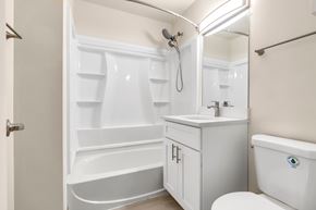 Villa Park apartment for rent - A white bathroom with a tub, sink, and toilet.
