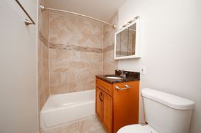 Villa Park apartment for rent - A bathroom with a white tub, a sink, and a toilet.