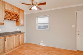 Villa Park apartment for rent - A room with wooden floors and a ceiling fan.