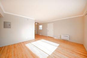 Villa Park apartment for rent - A room with wooden floors and white walls.