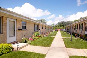 Villa Park apartment for rent - A row of houses with a sidewalk in front.