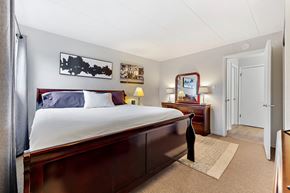 Lemont apartment for rent - a bedroom with a bed and a dresser