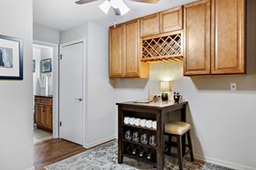Lemont apartment for rent - a kitchen with wood cabinets and a bar with a wine rack