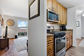Lemont apartment for rent - a kitchen with stainless steel appliances and a clock on the wall