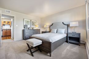 Downers Grove apartment for rent - A bedroom with a large bed and a chair.