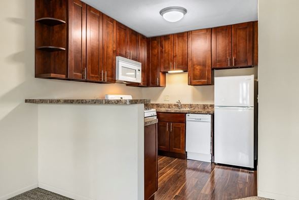 Lombard apartment for rent - A kitchen with wooden cabinets and a white refrigerator.