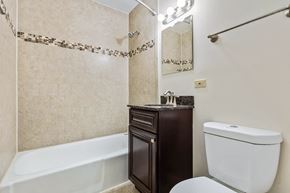 Lombard apartment for rent - A white toilet sits next to a bathtub in a bathroom.