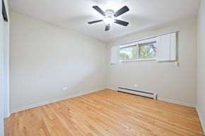 Villa Park apartment for rent - an empty living room with wood flooring and a ceiling fan