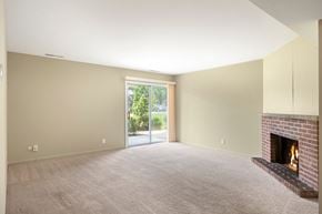 Sleepy Hollow apartment for rent - A living room with a fireplace and a sliding glass door.