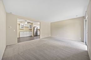 Sleepy Hollow apartment for rent - the living room and kitchen of an empty home with a carpeted floor