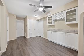 Sleepy Hollow apartment for rent - a renovated living room with white cabinets and a ceiling fan