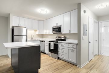 Oak Lawn apartment for rent - A modern kitchen with white cabinets and stainless steel appliances.