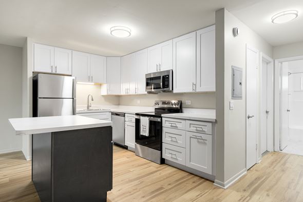 Oak Lawn apartment for rent - A modern kitchen with white cabinets and stainless steel appliances.