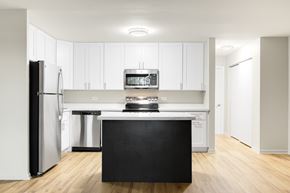 Oak Lawn apartment for rent - A kitchen with a black island in the middle.