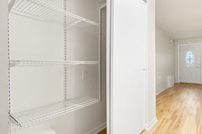 Oak Lawn apartment for rent - Empty white shelves in a room with a doorway leading to another room.