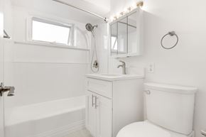 Oak Lawn apartment for rent - A white bathroom with a toilet, sink, and bathtub.