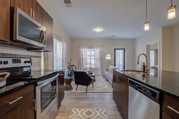 Grand Rapids apartment for rent - a kitchen with an island and a living room with a couch
