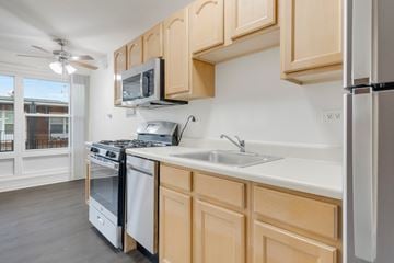 Downers Grove apartment for rent - A kitchen with wooden cabinets and a white countertop.