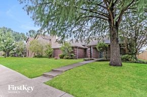 Mesquite house for rent - a brick house with a lawn and a tree in front of it