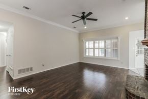 Mesquite house for rent - a living room with hardwood floors and a ceiling fan