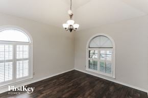Mesquite house for rent - an empty living room with a large window and a chandelier