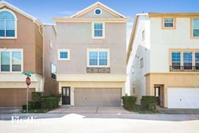 Houston house for rent - a street view of two buildings with a garage door