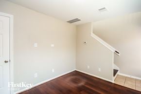Houston house for rent - a empty room with wood flooring and a white wall