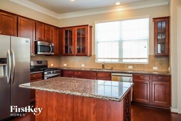 Houston house for rent - an updated kitchen with cherry wood cabinets and granite counter tops