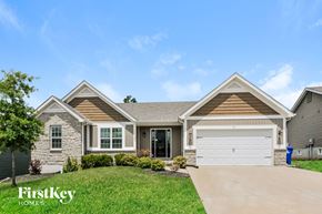 Wentzville house for rent - A house with a garage and a driveway in front of it.