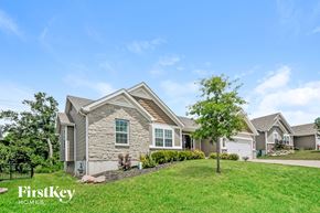 Wentzville house for rent - A house with a well-maintained lawn and a clear blue sky above.