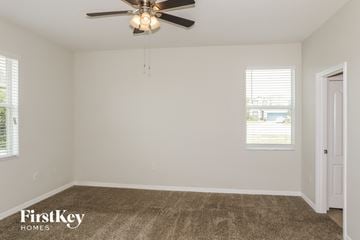Davenport house for rent - a living room with carpet and a ceiling fan