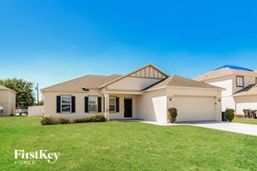 Poinciana house for rent - A house with a white garage door and a brown roof is shown.
