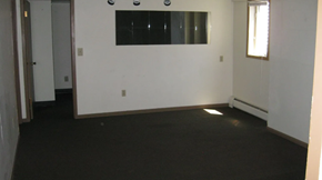 Moorhead house for rent - A room with a black floor and white walls.