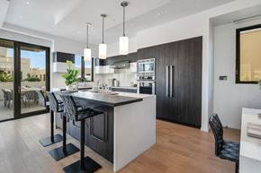 Beverly Hills apartment for rent - A modern kitchen with a bar area and a dining table.