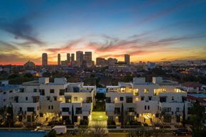 Beverly Hills apartment for rent - A cityscape at dusk with buildings illuminated and a clear sky.