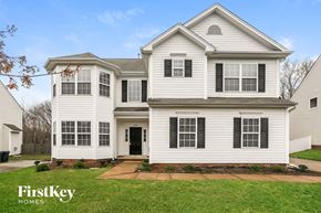 Huntersville house for rent - a white house with black shutters and a sidewalk in front