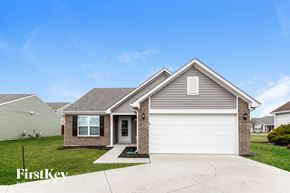 Shelbyville house for rent - a home with a white garage door and a brick house