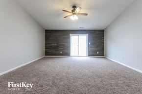 Shelbyville house for rent - the living room of an empty house with a ceiling fan