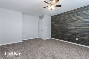 Shelbyville house for rent - the living room has a reclaimed wood wall and a ceiling fan