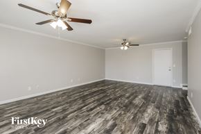 Mesa house for rent - the living room of a home with wood flooring and ceiling fans