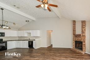 Houston house for rent - a kitchen and living room with a fireplace and a ceiling fan