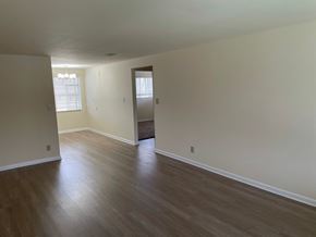 Kettering apartment for rent - A room with wooden floors and white walls.