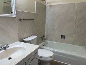 Kettering apartment for rent - A bathroom with a sink, toilet, and bathtub.