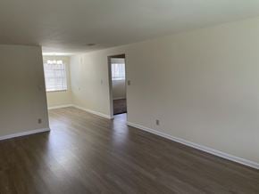 Kettering apartment for rent - an empty living room with wooden floors and white walls