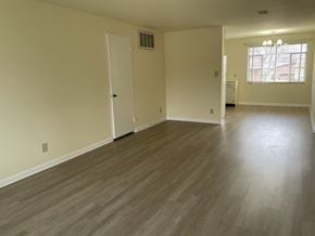 Kettering apartment for rent - an empty living room with wooden floors and a window