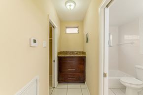 Hollywood apartment for rent - A bathroom with a toilet, sink, and window.