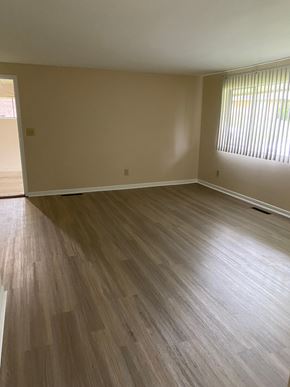 Kettering apartment for rent - an empty living room with wooden floors and a window