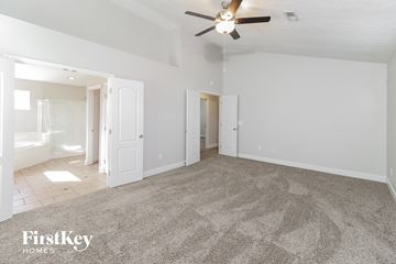 Maineville house for rent - a spacious living room with carpet and a ceiling fan