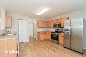 Winston-Salem house for rent - a kitchen with wooden cabinets and stainless steel appliances