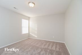 Winston-Salem house for rent - a bedroom with white walls and carpet and a window